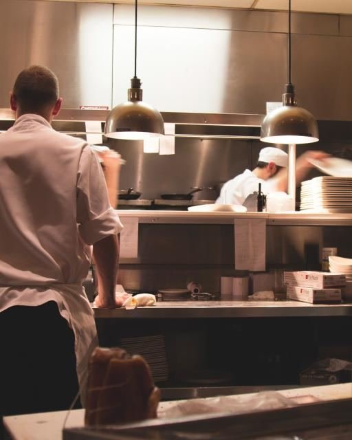 A chef preparing dishes in a restaurant kitchen
